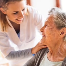 Elderly woman being cared for by nurse